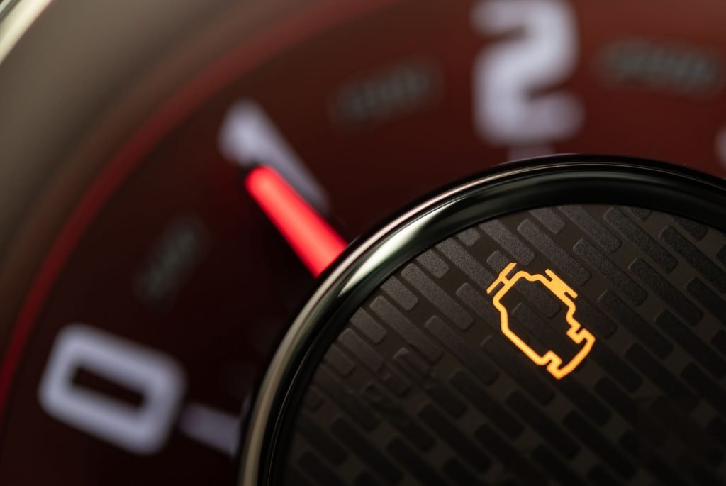 Close up of an engine check light on a car dashboard
